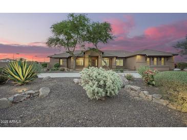 Charming home featuring desert landscaping, mature trees, and a welcoming entrance at 14188 W Hope Dr, Surprise, AZ 85379