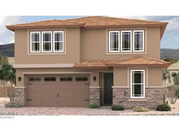 Two-story home with a two-car garage and decorative stone accents enhancing the facade at 16986 W Winston Dr, Goodyear, AZ 85338