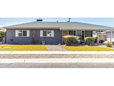 Charming single-story home featuring a well-maintained yard and neutral gray paint at 2715 E Edgemont Ave, Phoenix, AZ 85008