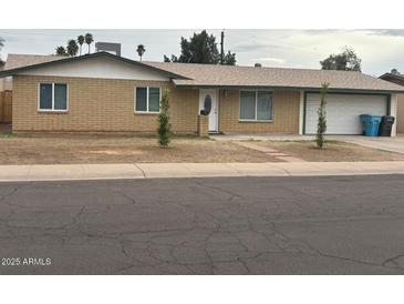 Charming single-story brick home with a well-maintained front yard and attached two-car garage at 3539 W Davidson Ln, Phoenix, AZ 85051