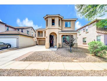 Charming two-story home featuring a front yard with decorative gravel and a welcoming entrance with a decorated door at 3745 E Flamingo Way, Gilbert, AZ 85297