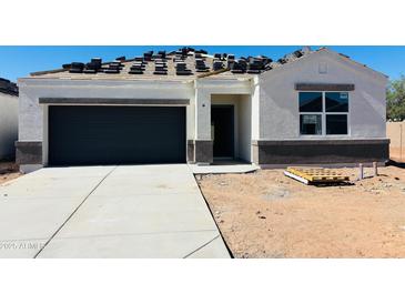 New construction home featuring a modern gray garage door and a bright white exterior at 5106 E Midnight Star Dr, San Tan Valley, AZ 85143