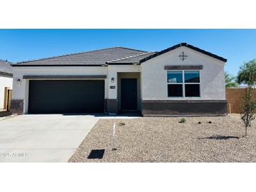 Charming single-story home featuring a black garage door and low-maintenance desert landscaping at 5106 E Midnight Star Dr, San Tan Valley, AZ 85143