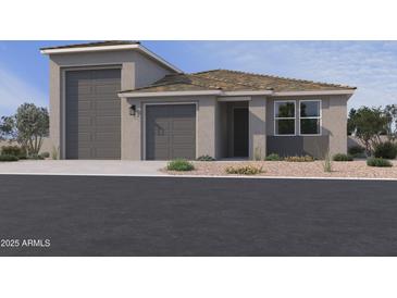 Charming single-story home with a three car garage, neutral color palette and desert landscaping at 15785 W Cheryl Dr, Waddell, AZ 85355