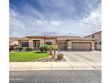 A sprawling ranch-style home boasts a three-car garage, desert landscaping, and a tile roof, adding to its curb appeal at 18249 W Mauna Loa Ln, Surprise, AZ 85388