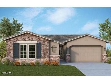 Charming single-story home features a brick facade, neutral stucco and a two-car garage at 21612 W Pierson St, Buckeye, AZ 85396
