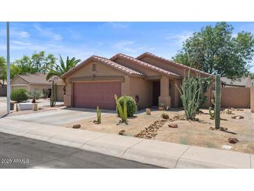Single-story home with desert landscaping, covered porch, and two-car garage at 2467 E Winchester Pl, Chandler, AZ 85286