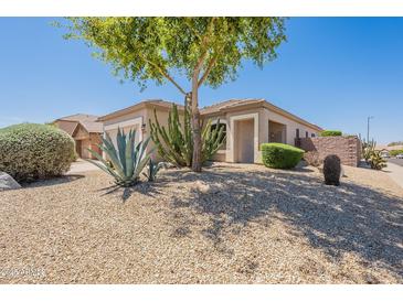 Charming home exterior with desert landscaping and a mature shade tree at 25860 N 47Th Pl, Phoenix, AZ 85050