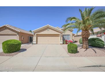Charming single-story home with a well-maintained front yard, desert landscaping, and a two-car garage at 3612 W Charlotte Dr, Glendale, AZ 85310