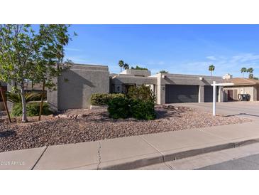 Stunning desert home featuring a spacious three-car garage and low-maintenance landscaping at 6126 E Paradise Ln, Scottsdale, AZ 85254
