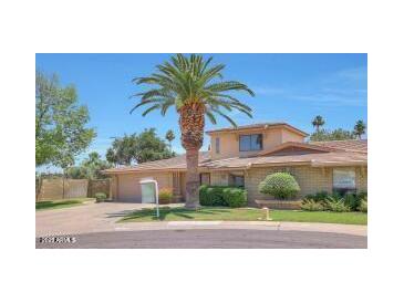Charming home featuring desert landscaping, mature palm trees, and a two-car garage at 8443 E Via De Los Libros --, Scottsdale, AZ 85258