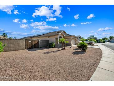 Inviting single story home with a two car garage and desert landscaping for easy maintenance at 14625 W Redfield Rd, Surprise, AZ 85379