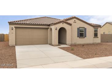 Charming single-story home featuring a neutral color palette, landscaped yard, and a two-car garage at 1409 E Jacqueline Pl, Casa Grande, AZ 85122