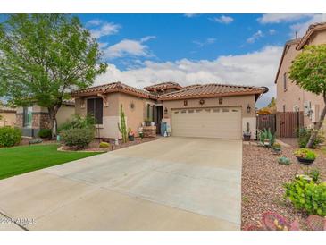 Charming home featuring a low-maintenance desert landscape and beautiful turf lawn at 17797 W Statler Dr, Surprise, AZ 85388