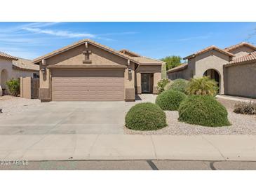 Charming single-story home featuring a two-car garage and desert landscaping in a well-maintained community at 2318 W Kristina Ave, San Tan Valley, AZ 85144