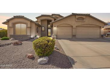 Charming single-story home featuring a well-manicured yard and a spacious two-car garage at 462 S Marie Dr, Chandler, AZ 85225