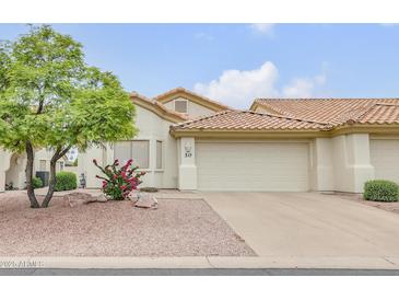 Charming home featuring a two-car garage, desert landscaping and a red tile roof at 5830 E Mckellips Rd # 30, Mesa, AZ 85215