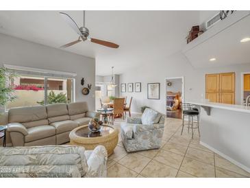 Bright living room with tile flooring, ceiling fan, neutral paint and backyard access at 5830 E Mckellips Rd # 30, Mesa, AZ 85215
