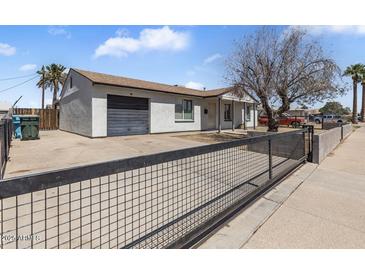 Charming single-story home with a well-maintained front yard and a convenient attached garage at 7720 W Indianola Ave, Phoenix, AZ 85033