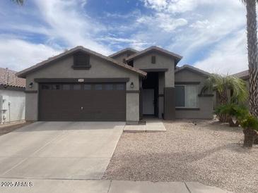 Charming single-story home with a well-maintained gravel front yard and a two-car garage at 3229 W Five Mile Peak Dr, San Tan Valley, AZ 85144