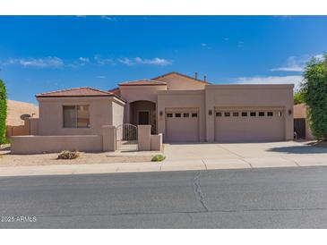 Charming single-story home with a gated front entry and a three car garage, perfect for modern living at 6043 W Robin Ln, Glendale, AZ 85310