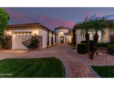 Charming single-story home featuring well-manicured landscaping, a three-car garage and a beautiful brick driveway at 3931 E Fox Cir, Mesa, AZ 85205