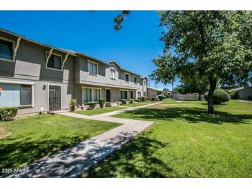 Charming townhomes with well-maintained lawns and mature trees, offering a serene community atmosphere at 2645 W Elm St, Phoenix, AZ 85017
