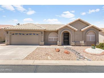 Charming single-story home featuring a low maintenance yard, covered entryway, and attached two-car garage at 6942 S Championship Dr, Chandler, AZ 85249