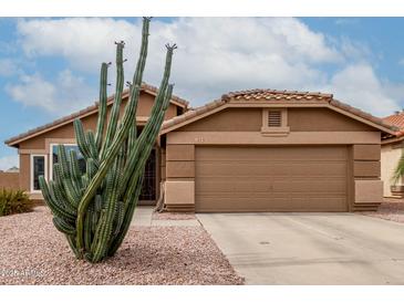 Charming single-story home with desert landscaping and a two-car garage at 1033 E Mountain Vista Dr, Phoenix, AZ 85048