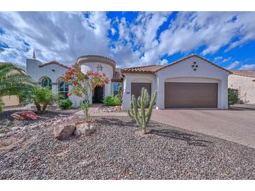 Charming stucco home featuring a tile roof, desert landscaping, and a spacious three-car garage at 16445 W Berkeley Rd, Goodyear, AZ 85395