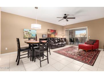 Inviting living room with a sliding glass door, modern ceiling fan, and a dining table set at 16626 E Westby Dr # 108, Fountain Hills, AZ 85268