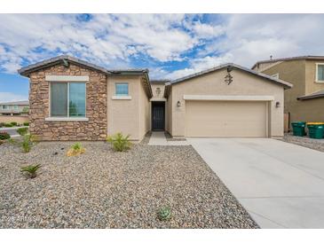 Charming single-Gathering home with stone accents, a two-car garage, and desert landscaping at 18766 W Montebello Ave, Litchfield Park, AZ 85340