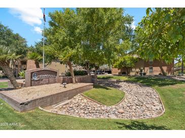 The Chesapeake Condominiums entrance features beautiful landscaping, rock features, and mature trees at 200 E Southern Ave # 133, Tempe, AZ 85282