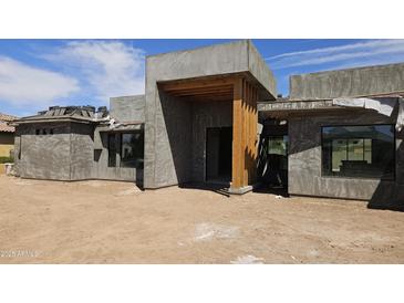 Exterior view of home under construction, featuring a modern design and natural wood accents at 3374 E Aquarius Ct, Chandler, AZ 85249