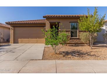 Charming single story home featuring low maintenance landscaping and a two car garage at 4050 W Coles Rd, Laveen, AZ 85339