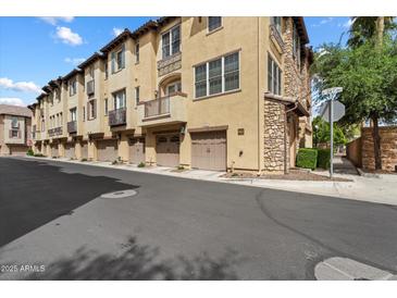 Beautiful three-story townhouse with stone accents, private garages, and charming balconies at 4411 N 24Th Way, Phoenix, AZ 85016