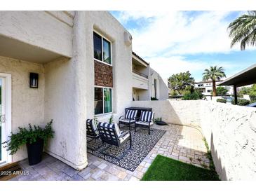 Inviting outdoor patio with stylish seating and attractive brick flooring offers a cozy, private retreat at 7350 N Via Paseo Del Sur -- # Q105, Scottsdale, AZ 85258