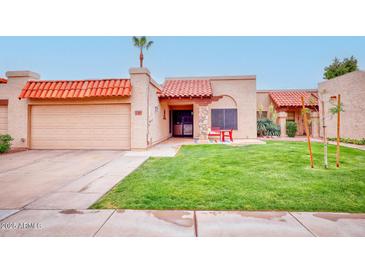 Charming single-story home boasts a well-maintained lawn, colorful bench, and inviting curb appeal at 873 W Sterling Pl, Chandler, AZ 85225
