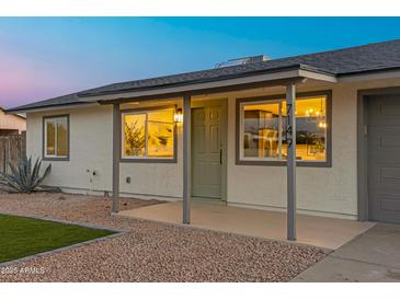 Charming single-story home featuring desert landscaping, covered porch, and a gray roof at 7149 E Jensen St, Mesa, AZ 85207