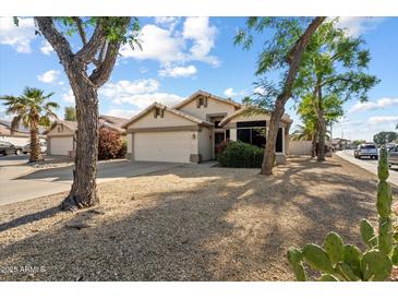 Charming single-story home featuring desert landscaping and a spacious two-car garage at 1024 N Ithica Ct, Chandler, AZ 85225