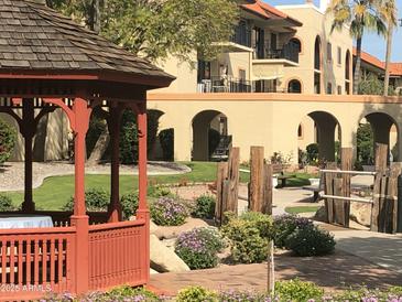 Attractive desert landscaping enhances this building in the community, with a gazebo and mature trees at 10330 W Thunderbird Blvd # B201, Sun City, AZ 85351