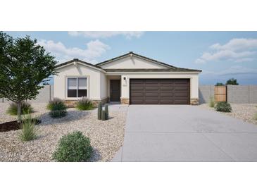 Charming single-story home featuring a neutral color palette, desert landscaping and a two-car garage at 1442 W Tigua Way, Coolidge, AZ 85128