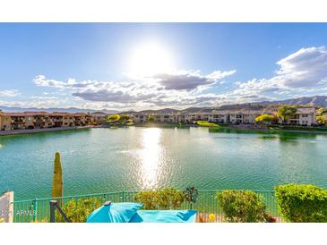 Expansive lake view showcasing the community's waterfront living and mountain views in the distance at 16226 S 11Th Pl, Phoenix, AZ 85048