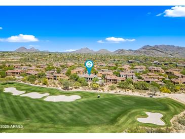 Beautiful aerial view of a scenic golf course with lush green fairways and sand traps in Scottsdale, Arizona at 20750 N 87Th St # 2038, Scottsdale, AZ 85255
