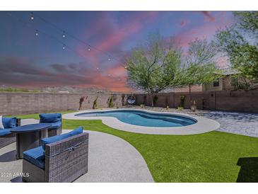 Enjoy a private pool and patio with stylish seating under string lights and stunning sunset views at 2405 W Cordia Ln, Phoenix, AZ 85085