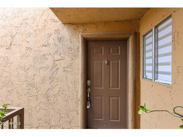 Inviting front door with decorative details and secure entry system at 8260 E Arabian Trl # 257, Scottsdale, AZ 85258
