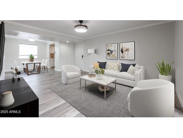 Bright living room featuring modern decor, light gray walls, stylish furniture, and durable wood-look flooring at 8260 E Arabian Trl # 257, Scottsdale, AZ 85258