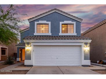 Charming two-story home featuring a large two car garage, beautiful blue siding, and a lovely tiled roof at 10831 E Azalea Ave, Mesa, AZ 85208