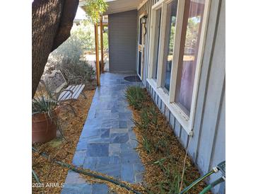 Charming front porch with stylish slate tile, bench, and large windows at 12607 N 23Rd St, Phoenix, AZ 85022