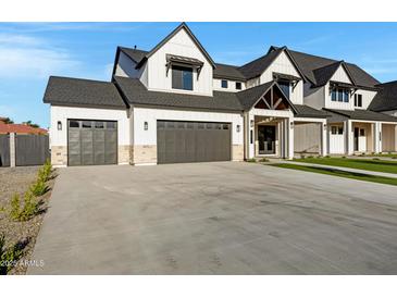 Striking two-story home featuring a three-car garage and modern farmhouse design at 26631 S 169Th Pl, Queen Creek, AZ 85142